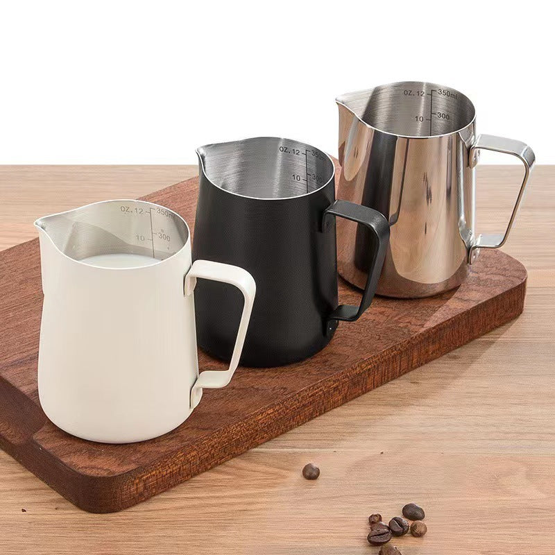 Three milk pitchers side by side — matte white, matte black and polished stainless