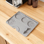 Gray silicone coffee machine mat protecting the countertop from drips