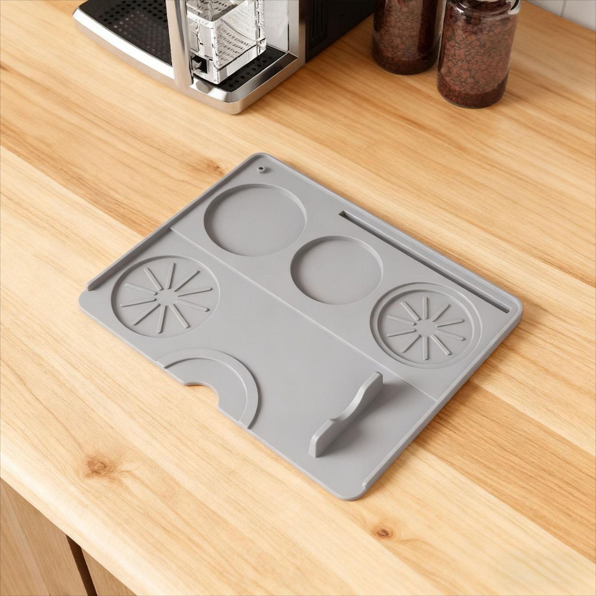 Gray silicone coffee machine mat protecting the countertop from drips