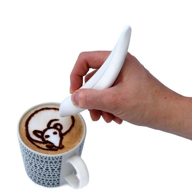 Electric latte art pen creating a design on cappuccino foam