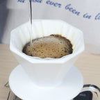 Pour-over brewing in the octagonal ceramic dripper over a glass carafe