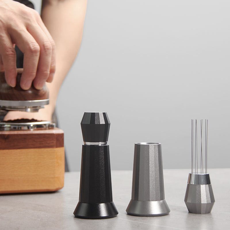 WDT Needle Tool with included magnetic stand keeping the tool upright on counter beside espresso machine