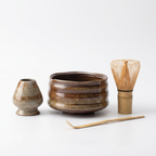 TrueShih The Matcha Ritual Essentials — complete 4-piece set in Autumn Wave: warm striated ceramic chawan, matching whisk holder, bamboo chasen and chashaku scoop on white