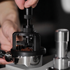 TrueShih Vertical Needle Distributor pressed straight down into the coffee bed, levelling the puck before tamping